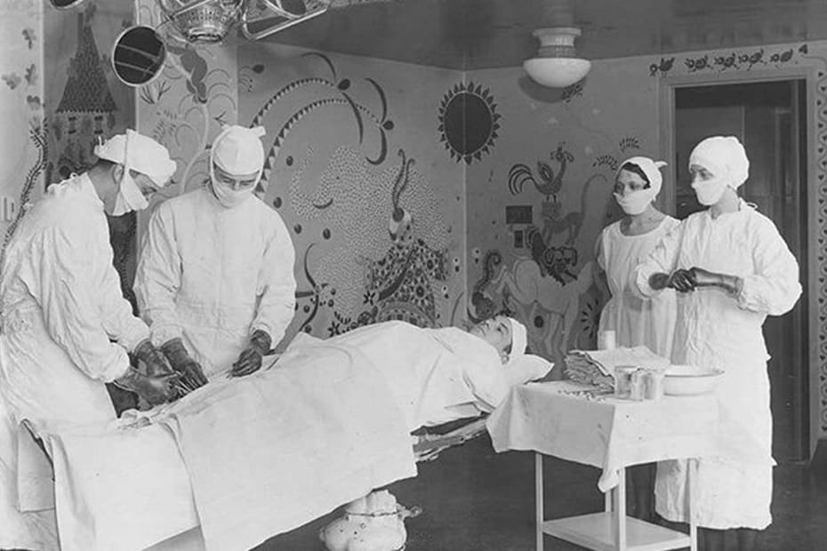 Black and white photo of Blair and nurses in operating room painted by Gisella Loeffel.