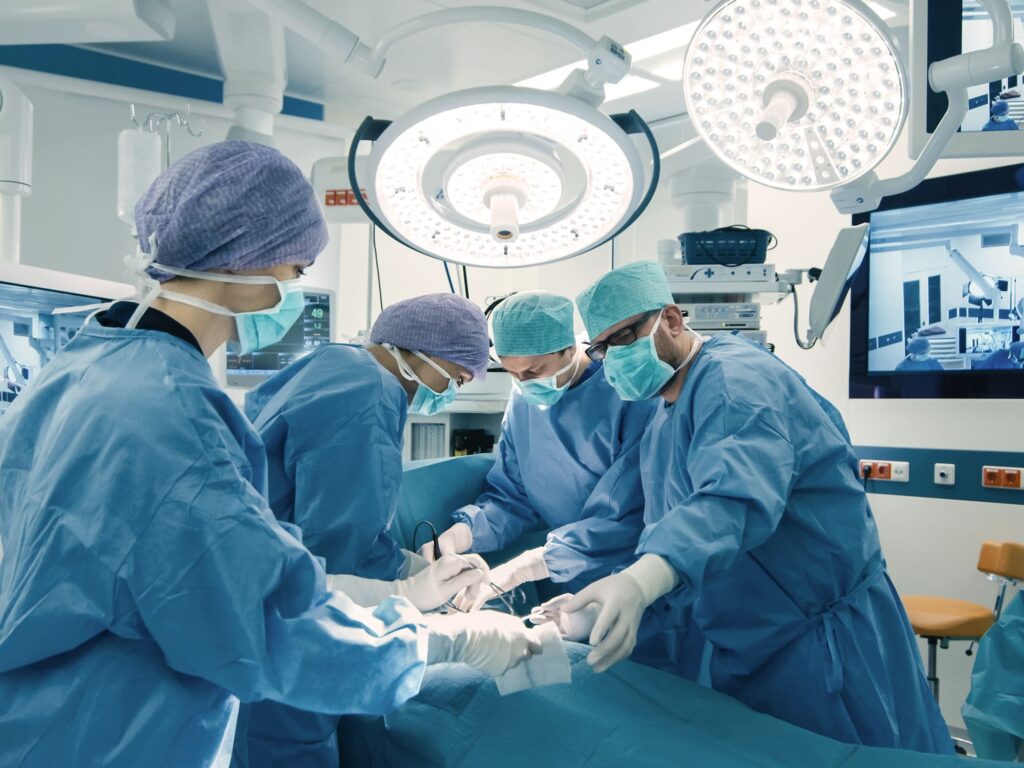 Medical Team Performing Surgical Operation in Bright Modern Operating Room.